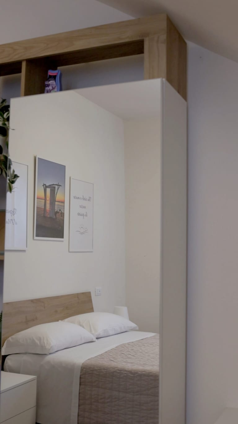 The Tramonto room: the double bed in the warm light of evening